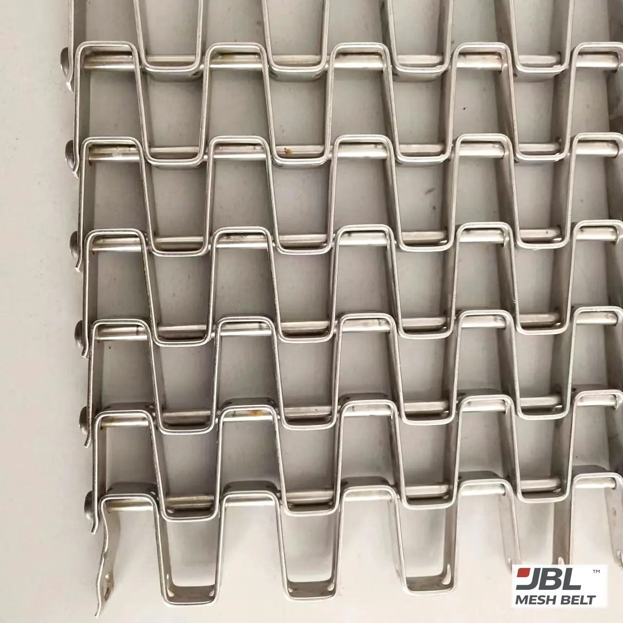 Belt lying flat, washer-welded edge