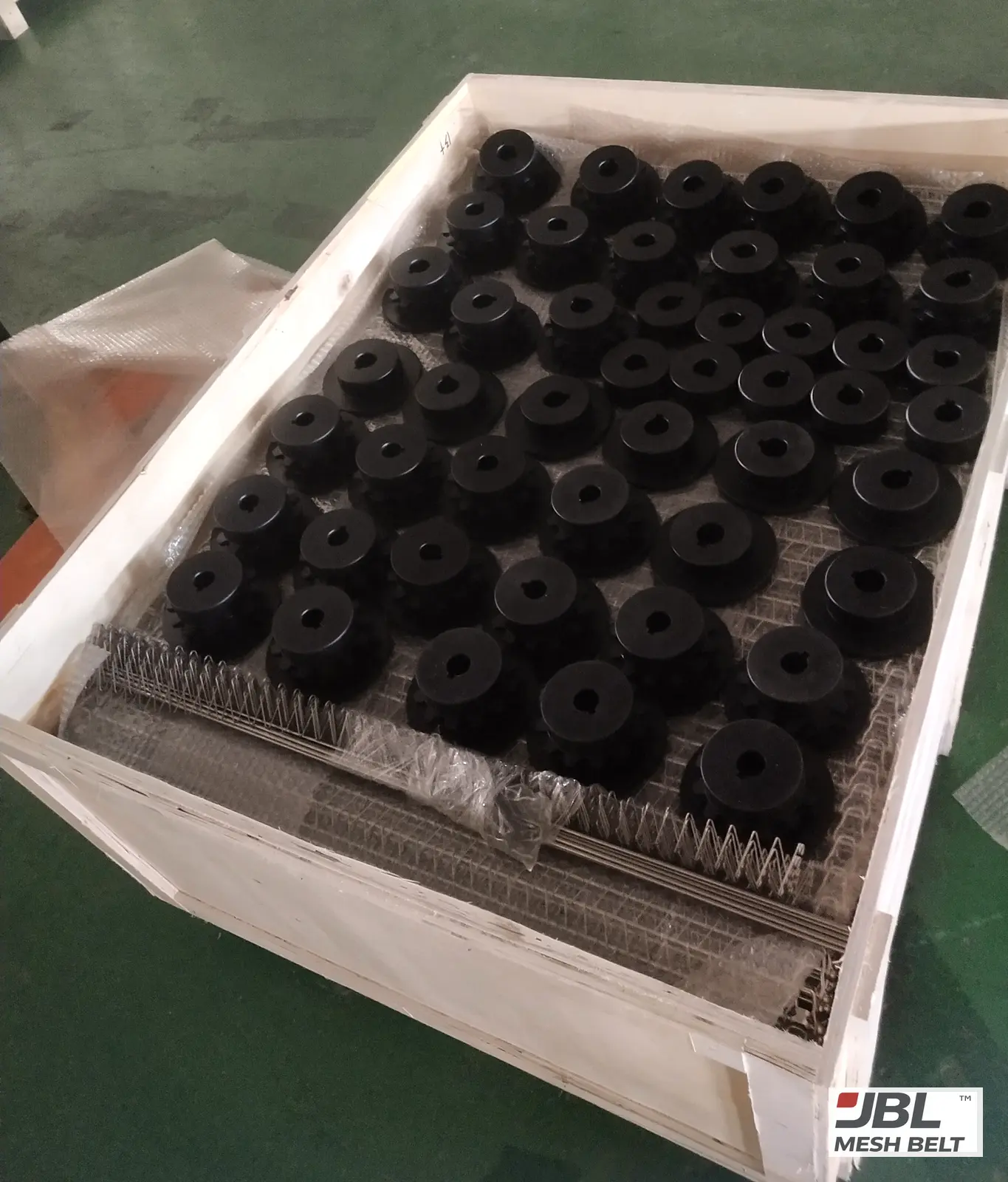 Sprockets packed on the belt in a lined crate