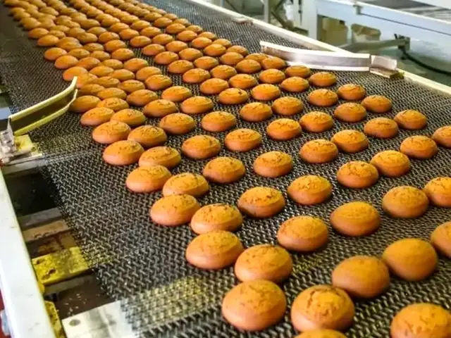 Bakery products on a metal conveyor belt line